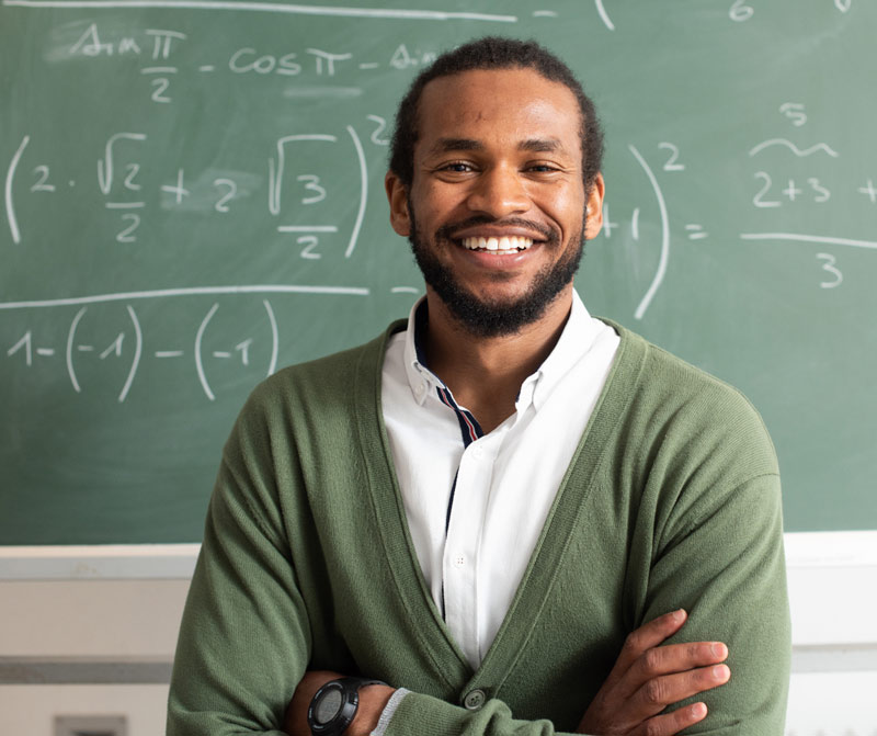 teacher with math board behind him